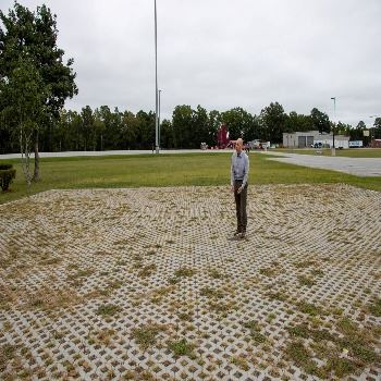 Doug Keller of RK&K Services standing on the new permeable pavement parking lot at BCCC